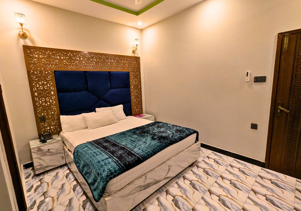 Master Room with ornate golden headboard at Dove Inn Executive Hotel
