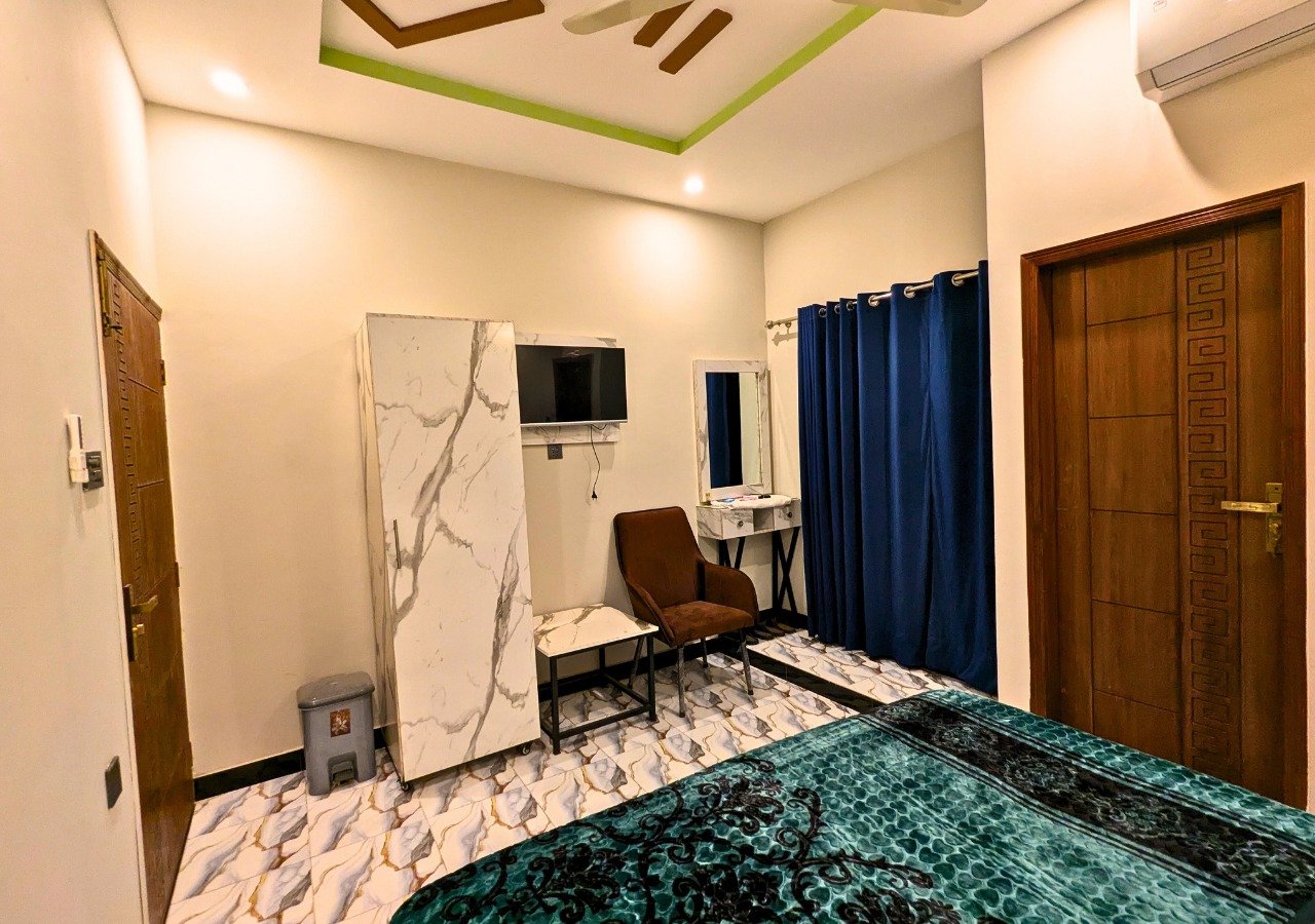 Room interior with wardrobe and LED TV